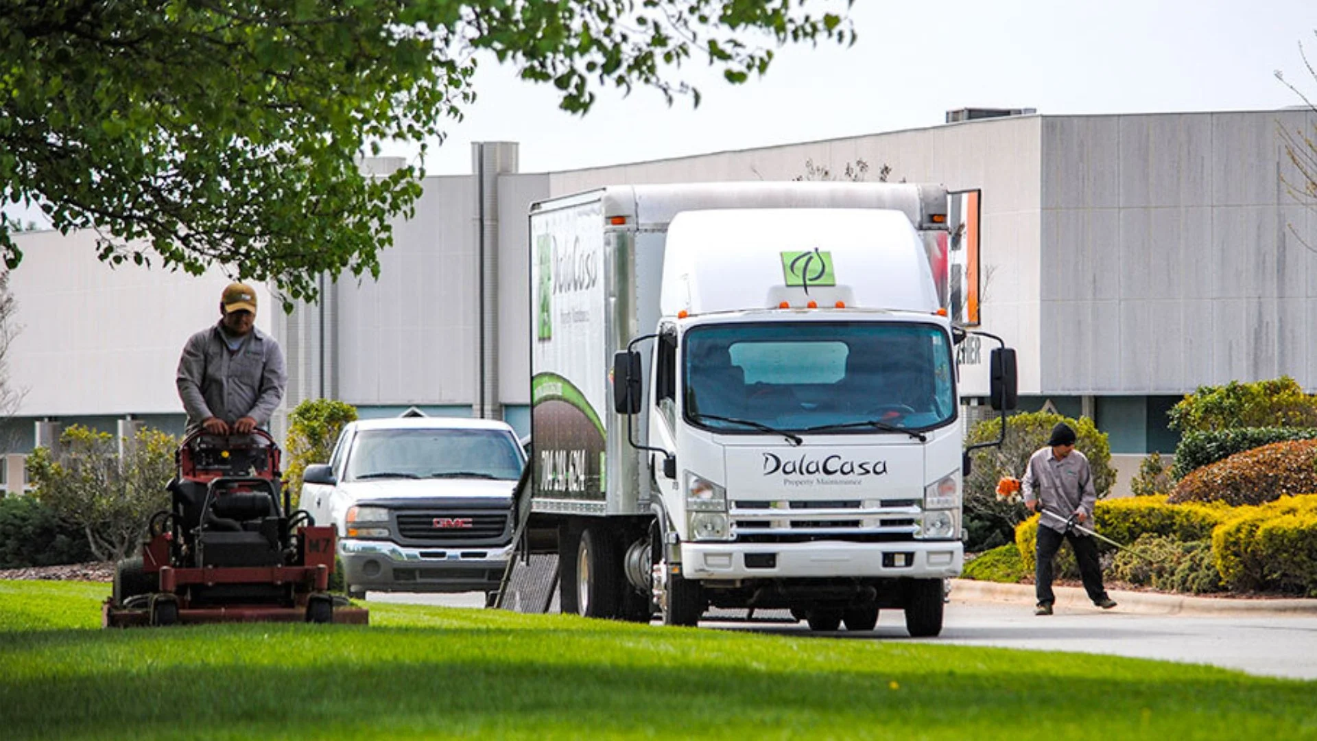Employees working on a lawn.