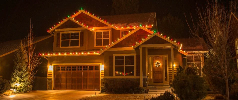 Colorful Christmas lights along the roof of a house in Charlotte, NC.