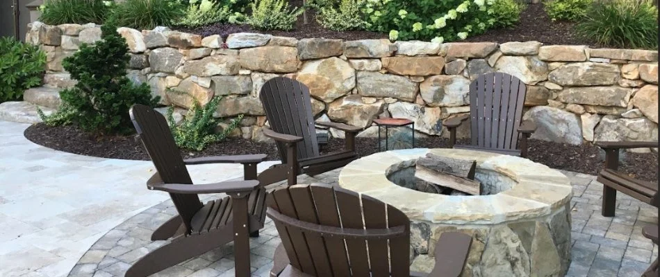 A fire pit on a patio with a retaining wall on a property in Indian Land,, NC.