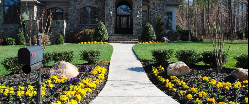 A house in Mooresville, NC, with a colorful landscape and manicured lawn.