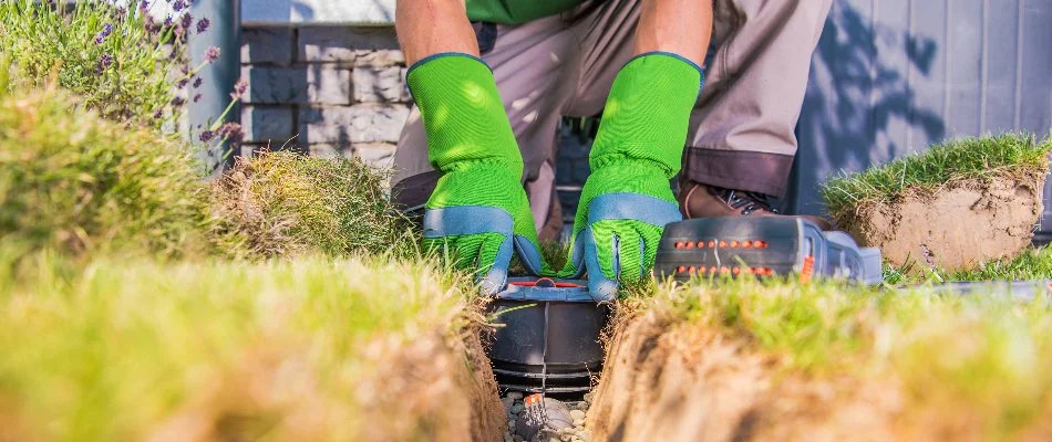 Worker installing an irrigation system in Lake Norman, NC.