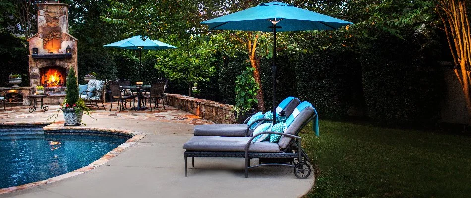 Pool area in Allen, NC, with chairs and a fireplace.