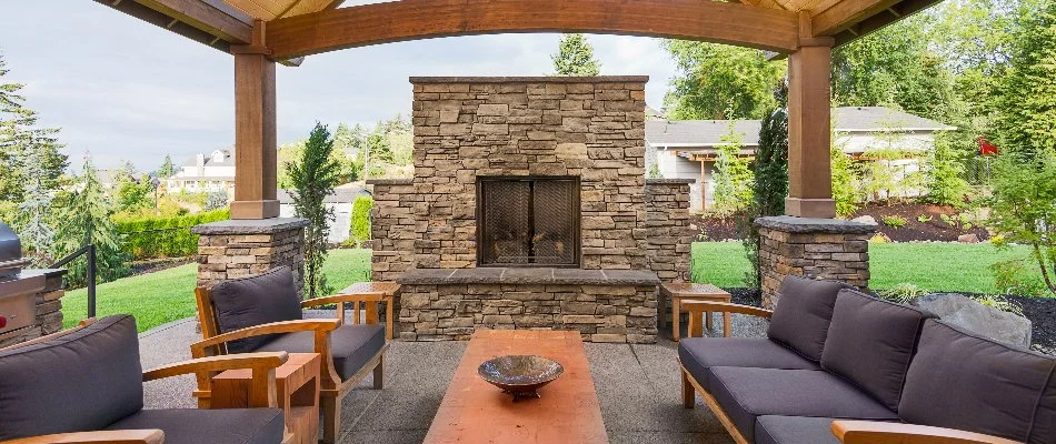 Stone outdoor fireplace in Charlotte, NC, with furniture.