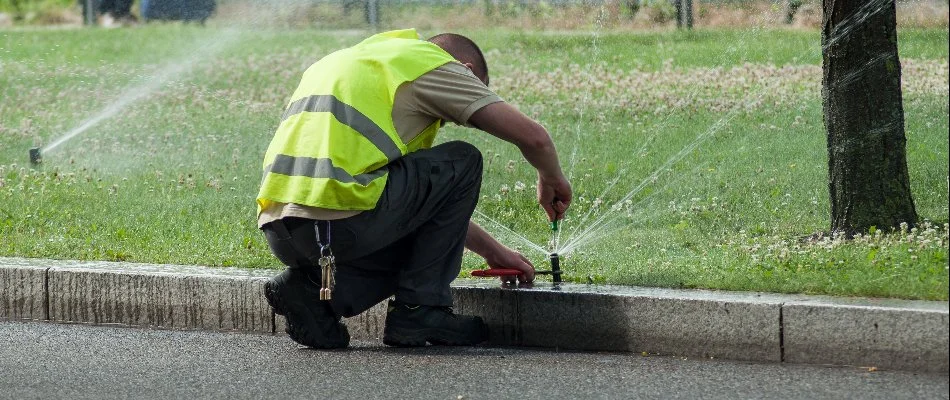 Worker repairing an irrigation system in Lake Norman, NC.